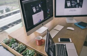 A modern workspace showing data analytics and AI-driven insights on large screens, symbolising strategic decision-making in operations management.